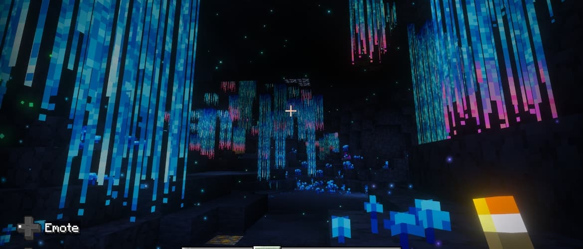 Minecraft underground cavern filled with dramatic hanging blue and pink bioluminescent plants and glowing particles.